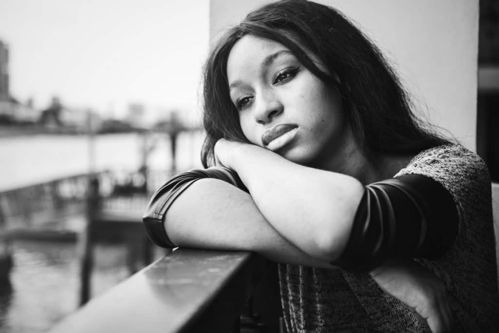 woman is sitting and contemplating