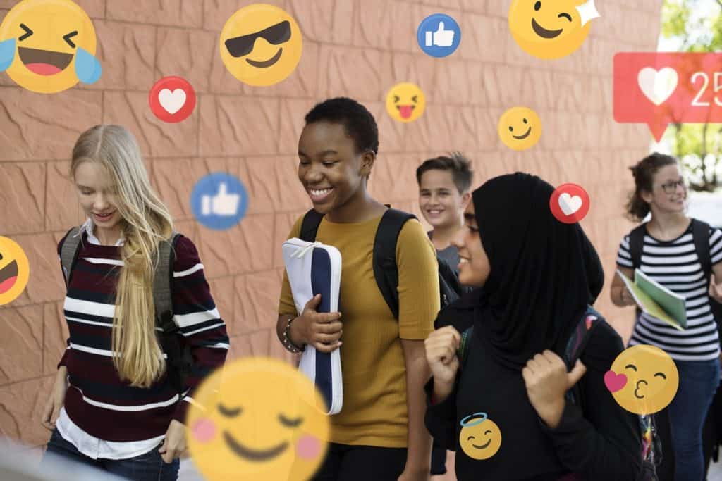Students walking and talking social media teens cyberbullying